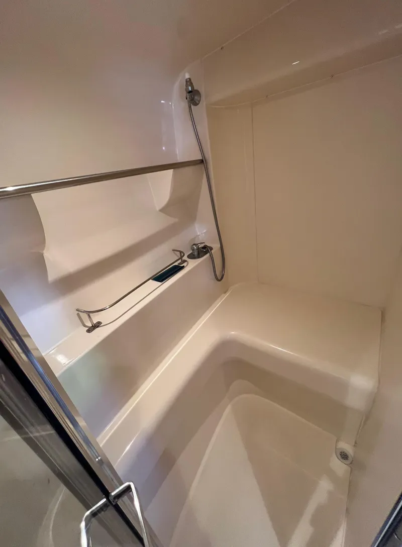 Slide: The Image of Shower area in a 1997 Carver 350 Mariner boat, featuring a sleek design. - 30
