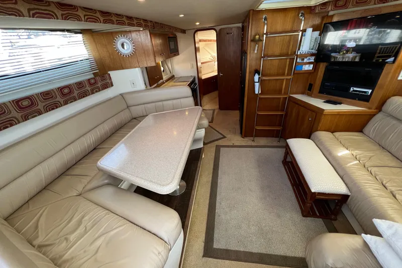 Slide: The Image of Interior of 1997 Carver 350 Mariner yacht with beige seating and wooden accents. - 20