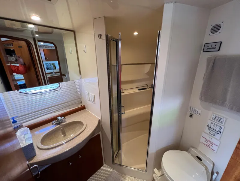 Slide: The Image of Bathroom interior of 1997 Carver 350 Mariner yacht with sink, shower, and toilet. - 28