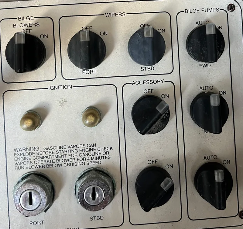 Slide: The Image of Control panel of a 1997 Carver 350 Mariner boat with switches and ignition keys. - 33