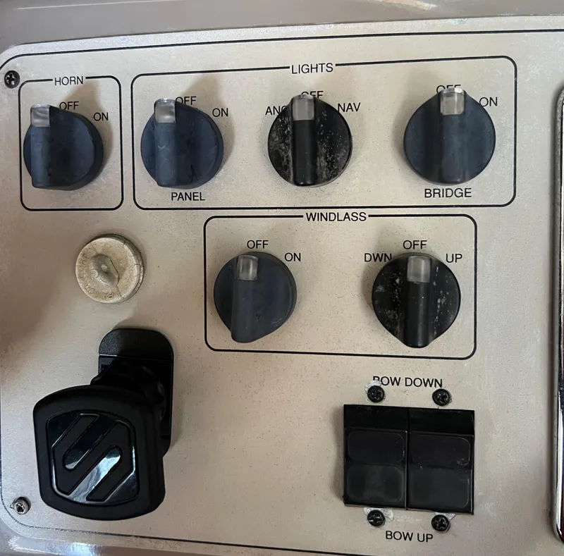 Slide: The Image of Control panel of a 1997 Carver 350 Mariner boat with various switches and knobs. - 34