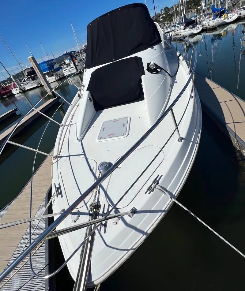 Slide: The Image of 1997 Carver 350 Mariner yacht docked in a serene marina setting. - 4