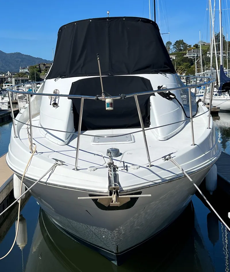 Slide: The Image of 1997 Carver 350 Mariner boat with cushioned seating, docked in a marina. - 6