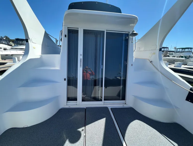 Slide: The Image of 1997 Carver 350 Mariner yacht docked, featuring spacious deck and marina view. - 8