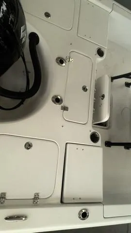 Slide: The Image of 2025 Sea Pro 230 Bay boat interior with storage compartments and seating. - 10