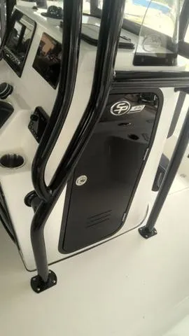 Slide: The Image of 2025 Sea Pro 230 Bay boat console with black railings and control panel. - 14