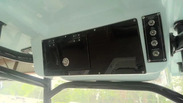 Slide: The Image of 2025 Sea Pro 230 Bay boat console with control panel and storage compartment. - 17