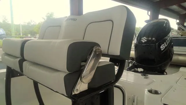 Slide: The Image of 2025 Sea Pro 230 Bay boat with cushioned seating and Suzuki outboard motor. - 5