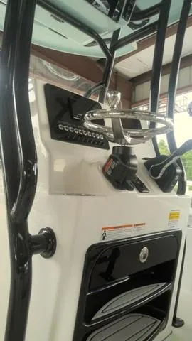 Slide: The Image of 2025 Sea Pro 230 Bay boat console with steering wheel and controls. - 7