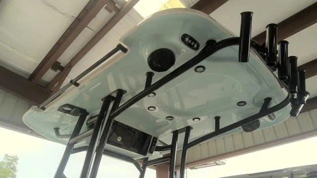 Slide: The Image of 2025 Sea Pro 230 Bay boat underside view with rod holders and speakers. - 8