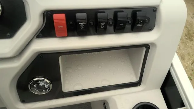 Slide: The Image of Control panel of 2025 Godfrey Pontoons Xperience 2286 SBX Sport Tube, featuring switches and storage. - 10