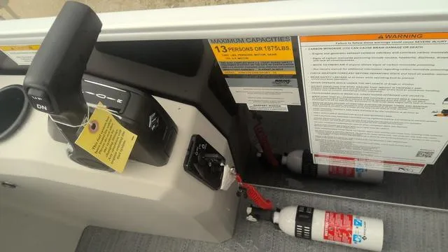 Slide: The Image of 2025 Godfrey Pontoons Xperience 2286 SBX control panel with safety labels and fire extinguisher. - 11