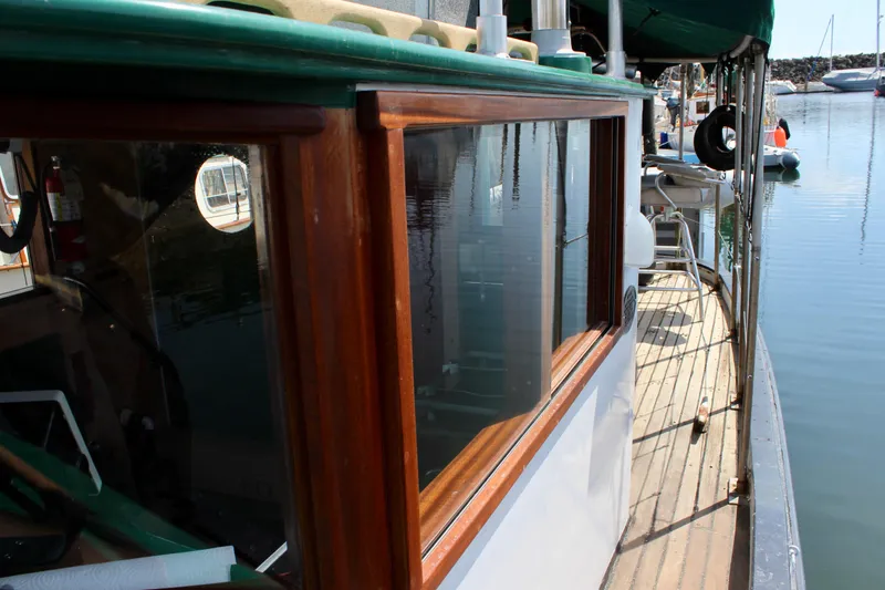 Slide: The Image of 1961 Custom 32' William Garden Tugboat with wooden cabin details docked in a marina. - 10