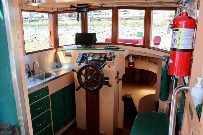Slide: The Image of Interior of 1961 Custom 32' William Garden Tugboat with steering wheel and kitchenette. - 17