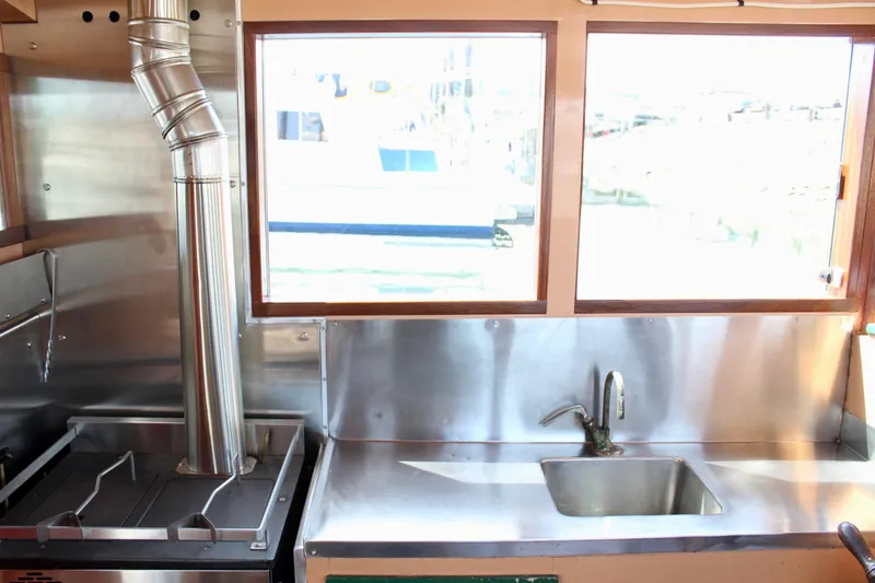 Slide: The Image of Interior of 1961 Custom 32' William Garden Tug with stainless steel kitchen and sink. - 19
