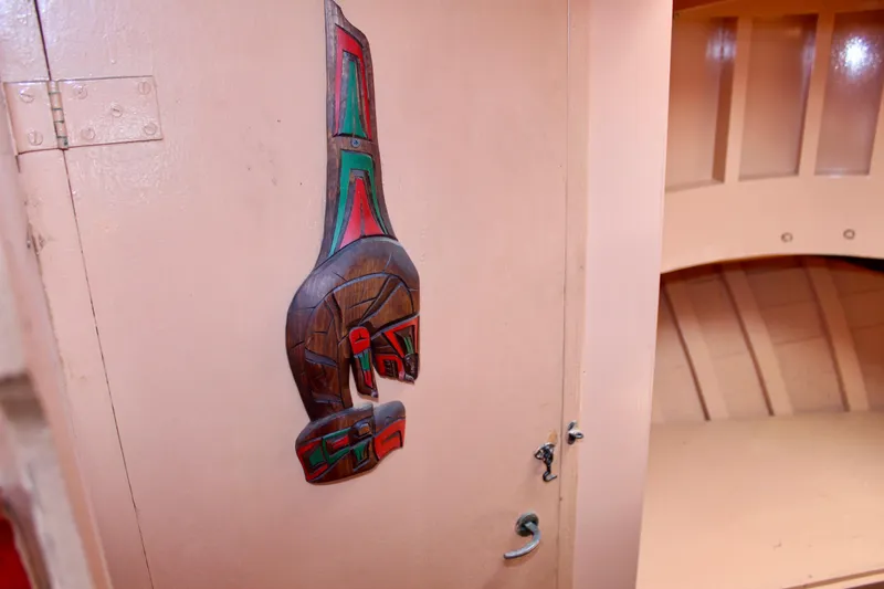 Slide: The Image of Interior of 1961 Custom 32' William Garden Tug with decorative wooden carving on door. - 29