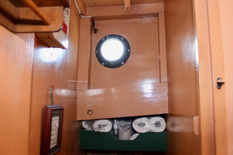 Slide: The Image of Interior of 1961 Custom 32' William Garden Tug with porthole and storage shelves. - 31