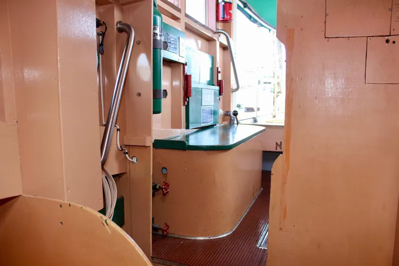 Slide: The Image of Interior of 1961 Custom 32' William Garden Tug, featuring a compact kitchen area. - 34