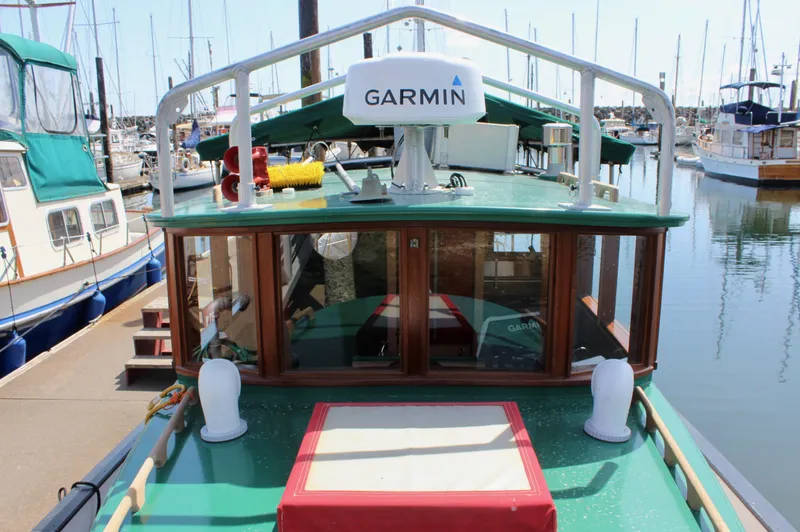Slide: The Image of 1961 Custom 32' William Garden Tug with Garmin equipment, docked in a marina. - 8