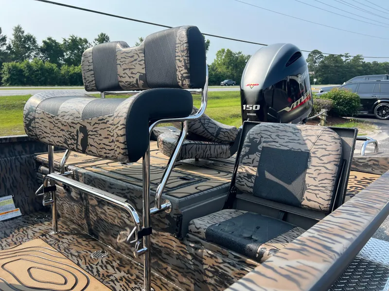 Slide: The Image of 2025 Xpress H20B boat with camo seats and Yamaha 150 engine. - 10