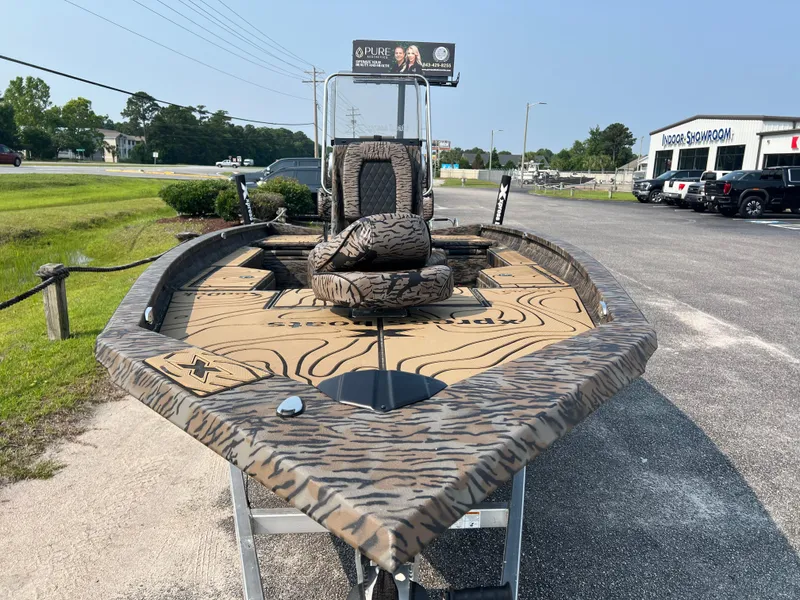 Slide: The Image of 2025 Xpress H20B boat with camouflage design on display outdoors. - 7