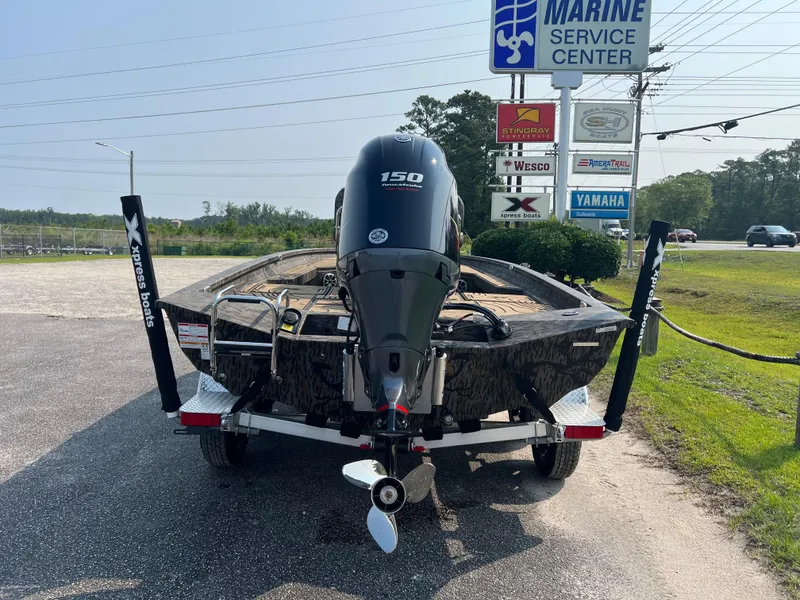 Slide: The Image of 2025 Xpress H20B boat on trailer at marine service center. - 8