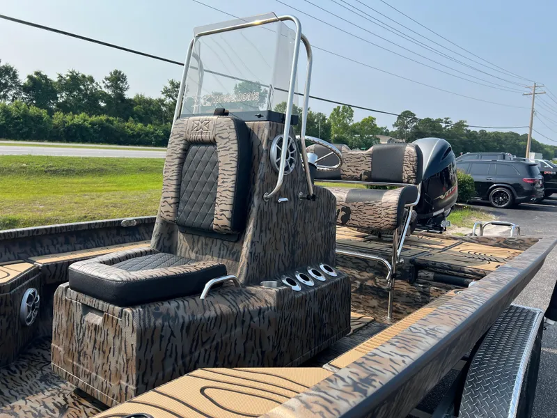 Slide: The Image of 2025 Xpress H20B boat with camouflage design and modern seating. - 9