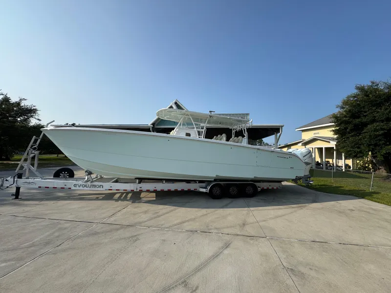 The Image of 2022 Invincible 40 Catamaran on trailer, parked in driveway, sunny day. - 1