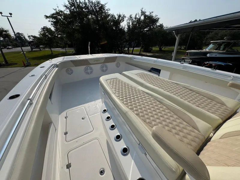 Slide: The Image of 2022 Invincible 40 Catamaran interior with beige seating and storage compartments. - 19