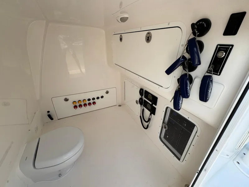 Slide: The Image of Invincible 40 Catamaran 2022 interior with toilet, control panel, and storage compartments. - 25