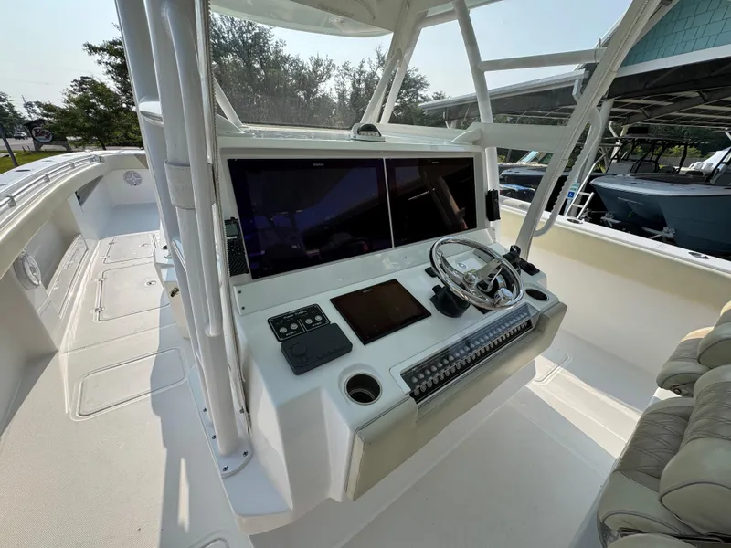 Slide: The Image of 2022 Invincible 40 Catamaran helm with dual screens and modern controls. - 29