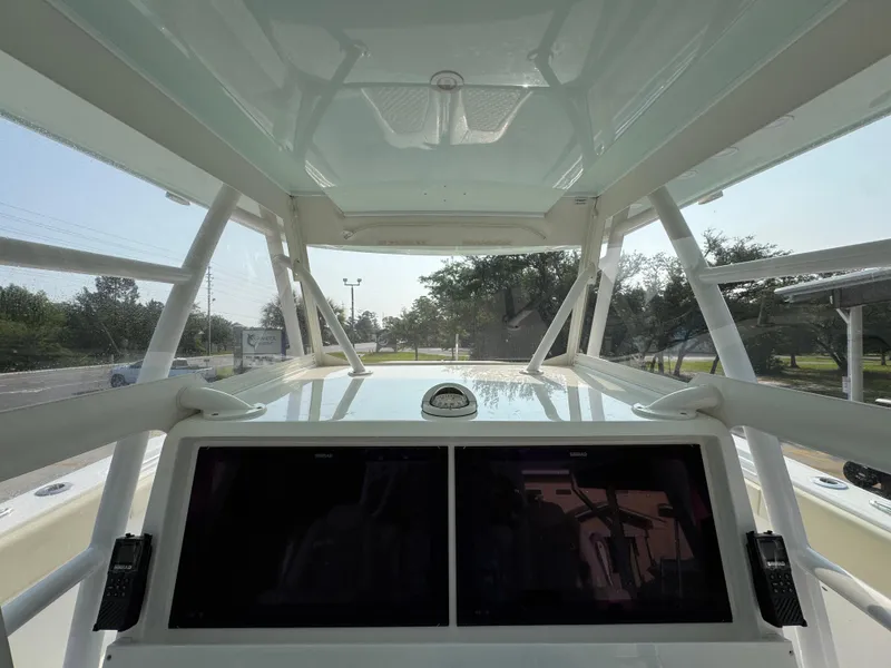 Slide: The Image of 2022 Invincible 40 Catamaran cockpit with dual screens and overhead canopy. - 31