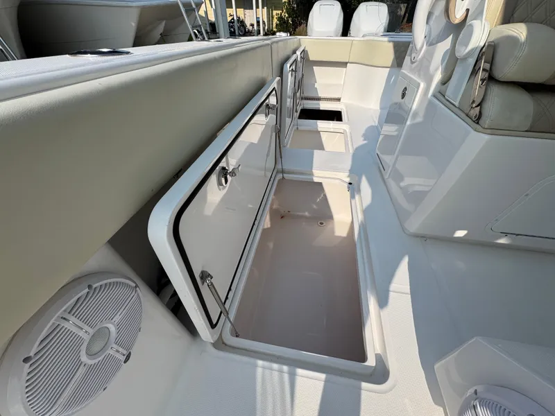 Slide: The Image of 2022 Invincible 40 Catamaran interior storage compartments and seating area. - 37