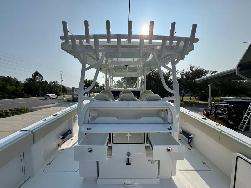 Slide: The Image of 2022 Invincible 40 Catamaran boat interior with seating and storage, under clear sky. - 40