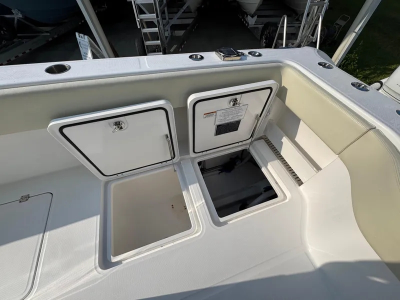 Slide: The Image of 2022 Invincible 40 Catamaran deck with storage compartments and seating area. - 41