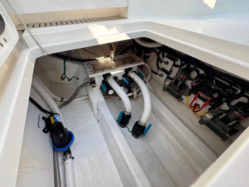 Slide: The Image of Engine compartment of 2022 Invincible 40 Catamaran with visible hoses and wiring. - 45