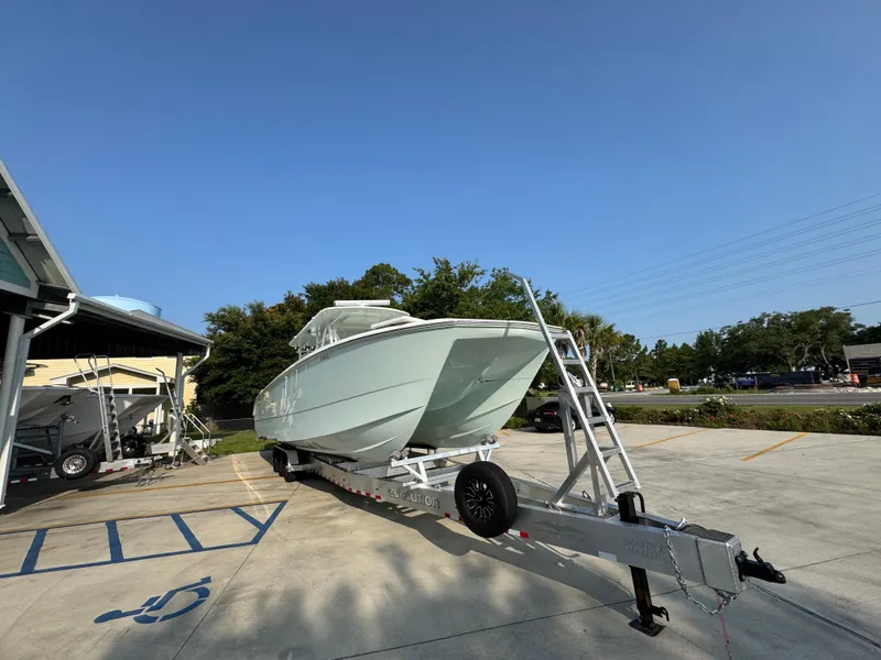 Slide: The Image of 2022 Invincible 40 Catamaran on trailer in parking lot, clear sky background. - 8