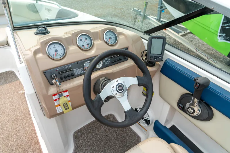 Slide: The Image of 2014 Chaparral 21 Ski & Fish H2O dashboard with steering wheel and gauges. - 13
