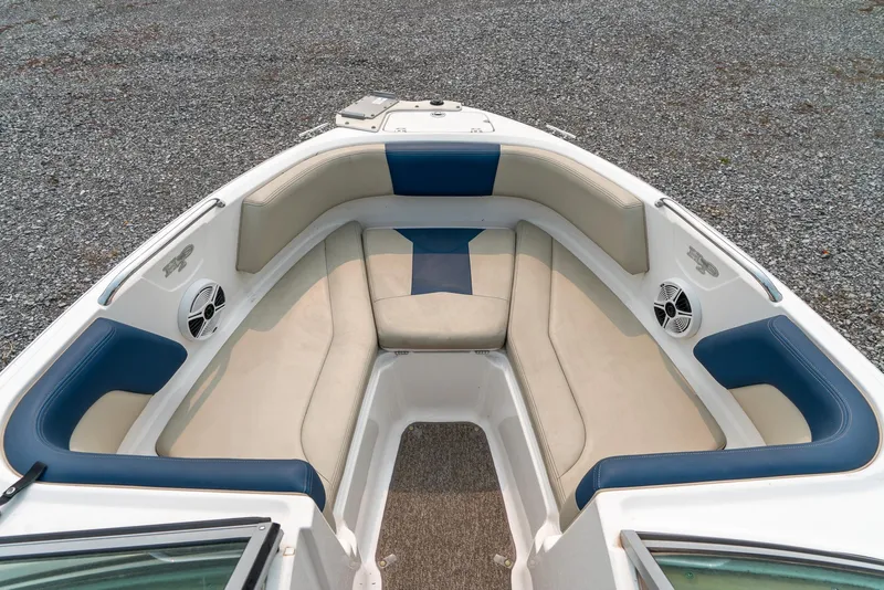 Slide: The Image of 2014 Chaparral 21 Ski & Fish H2O boat interior with cushioned seating and speakers. - 16