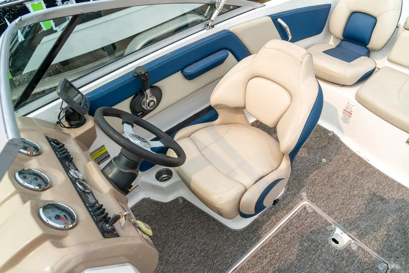 Slide: The Image of 2014 Chaparral 21 Ski & Fish H2O boat interior with beige and blue seating. - 19