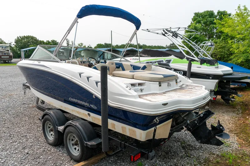 Slide: The Image of 2014 Chaparral 21 Ski & Fish H2O boat on trailer, parked outdoors. - 6