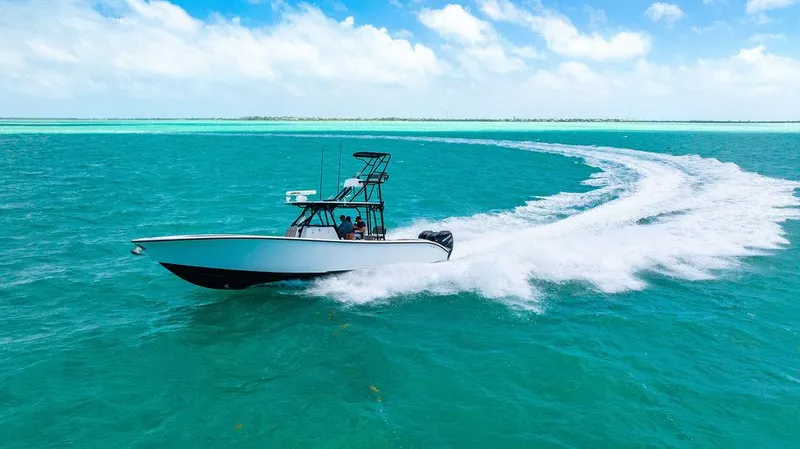 Slide: The Image of 2015 Yellowfin CC boat speeding on turquoise ocean under blue sky. - 1