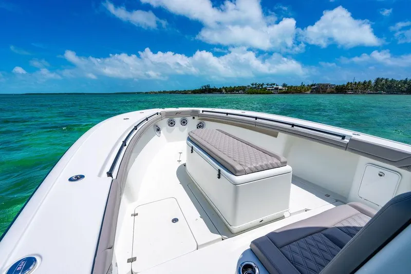 Slide: The Image of 2015 Yellowfin CC boat on clear turquoise water under a bright blue sky. - 11