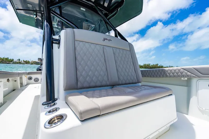 Slide: The Image of 2015 Yellowfin CC boat interior with cushioned seating and ocean view. - 13