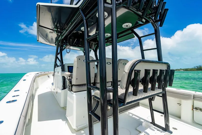 Slide: The Image of 2015 Yellowfin CC boat interior with seating and rod holders, set against a clear blue sky. - 18