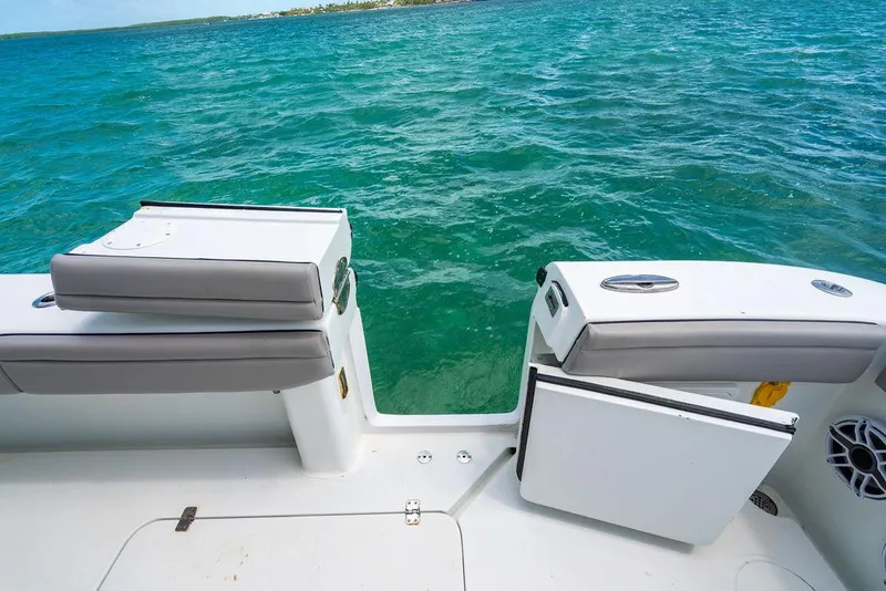 Slide: The Image of 2015 Yellowfin CC boat with open deck, overlooking clear blue ocean waters. - 21
