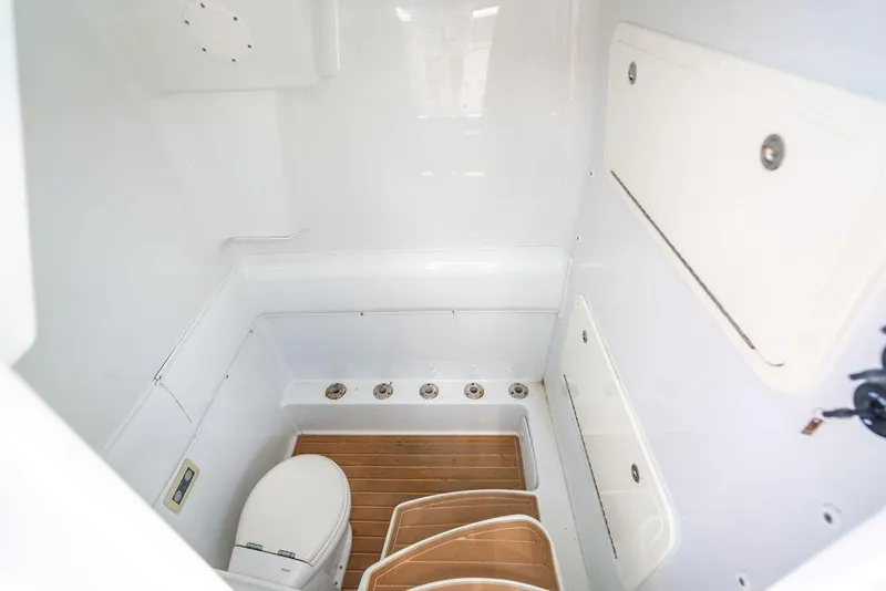 Slide: The Image of 2015 Yellowfin CC boat interior with toilet and wooden flooring. - 25