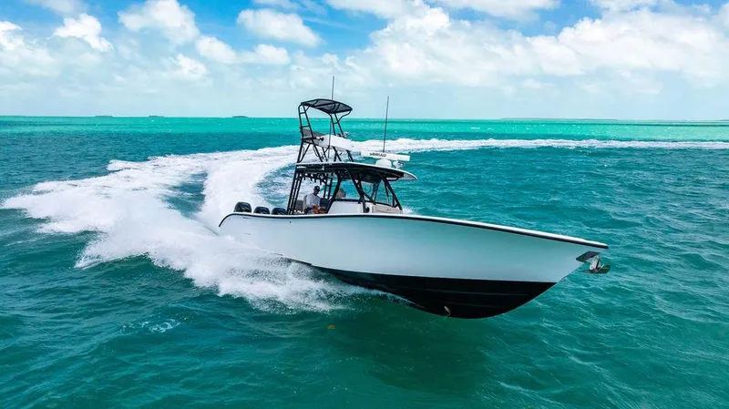 Slide: The Image of 2015 Yellowfin CC boat cruising on turquoise ocean waters under a blue sky. - 3