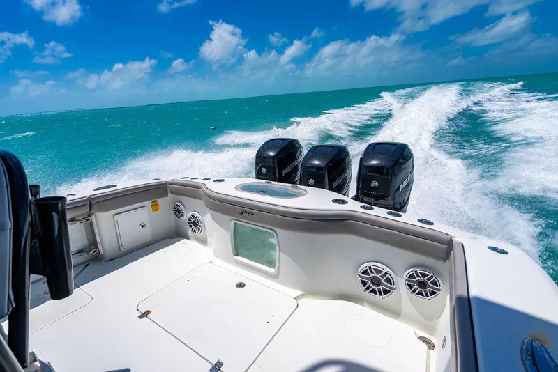 Slide: The Image of 2015 Yellowfin CC boat cruising on turquoise waters under a clear blue sky. - 4