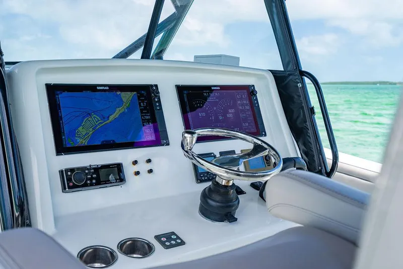 Slide: The Image of 2015 Yellowfin CC boat dashboard with navigation screens and steering wheel. - 7